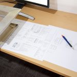 K2 Design services showing flat-lay plans of door designs on a desk