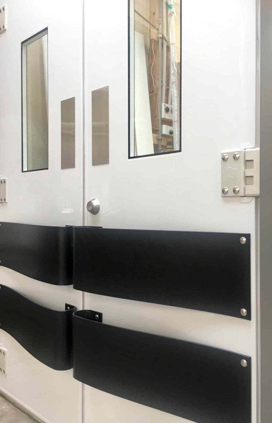 White K2 swing doors with wide black push bars and windows
